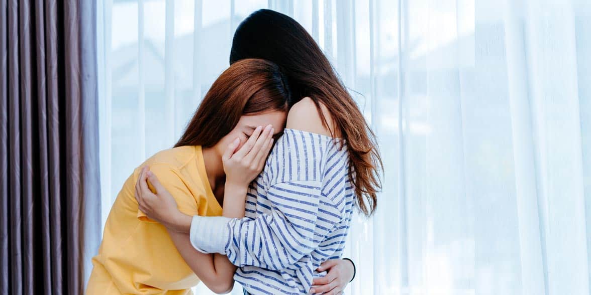 Photo of two women crying