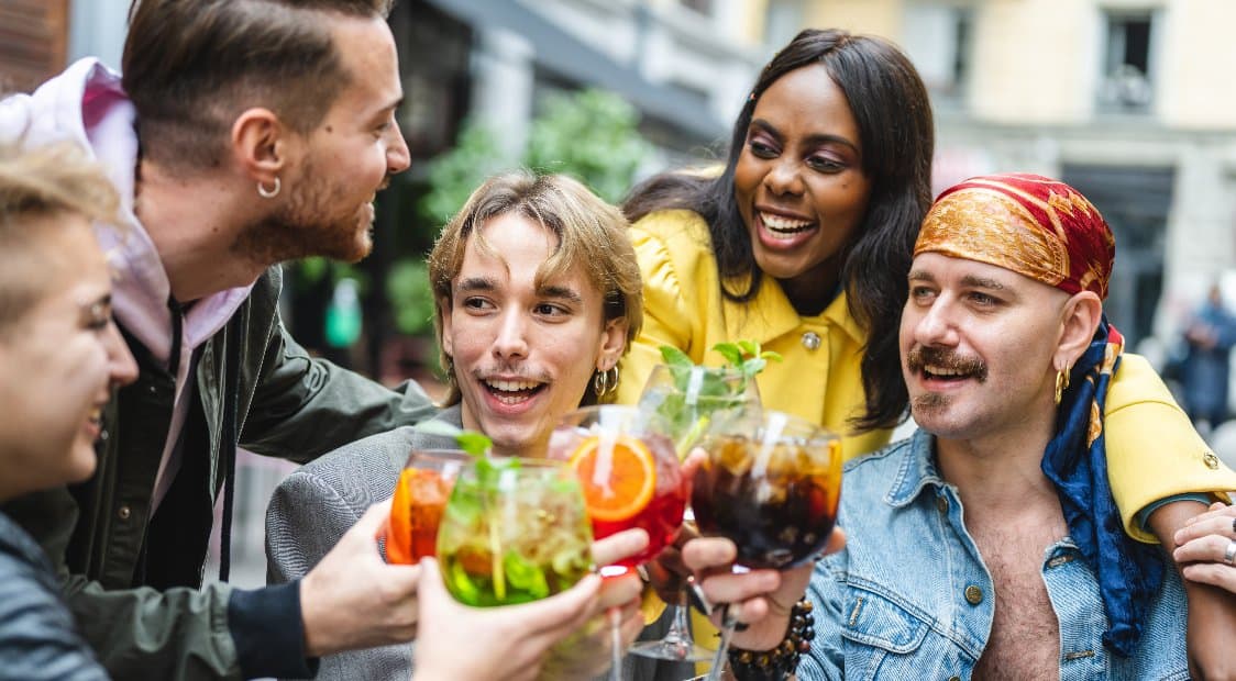 Friend group with drinks smiling