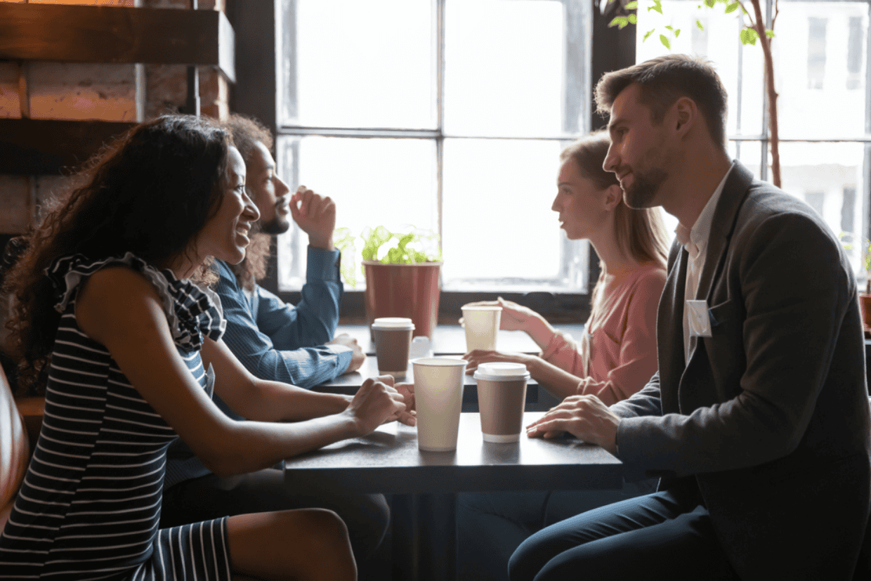 Several young men and women chatting at tables