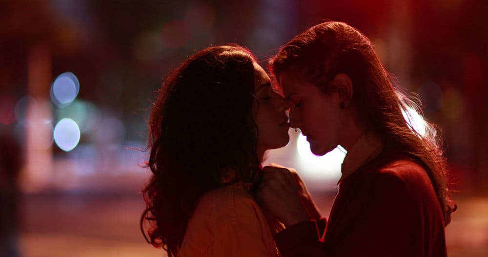 Lesbian girls kissing and caressing at night in the city