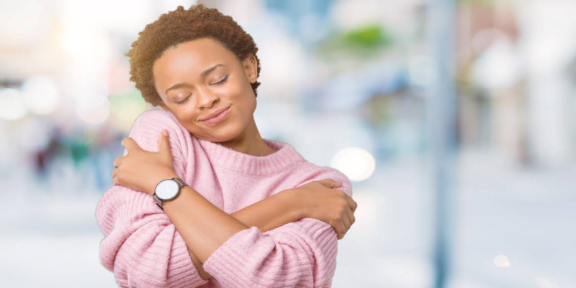 Photo of woman hugging herself