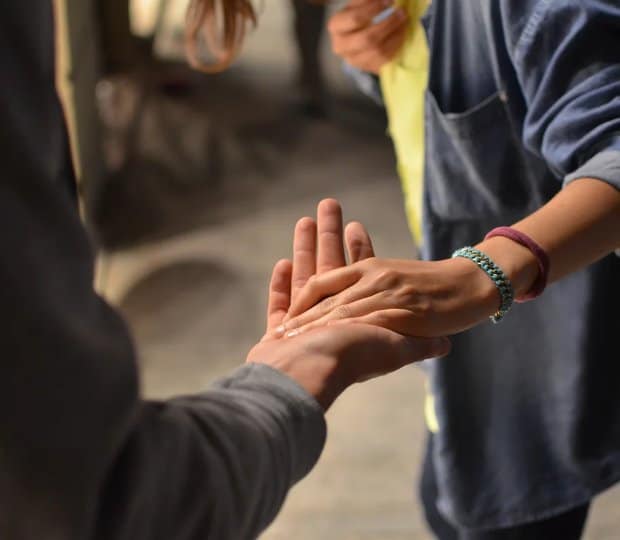 Two men holding hands