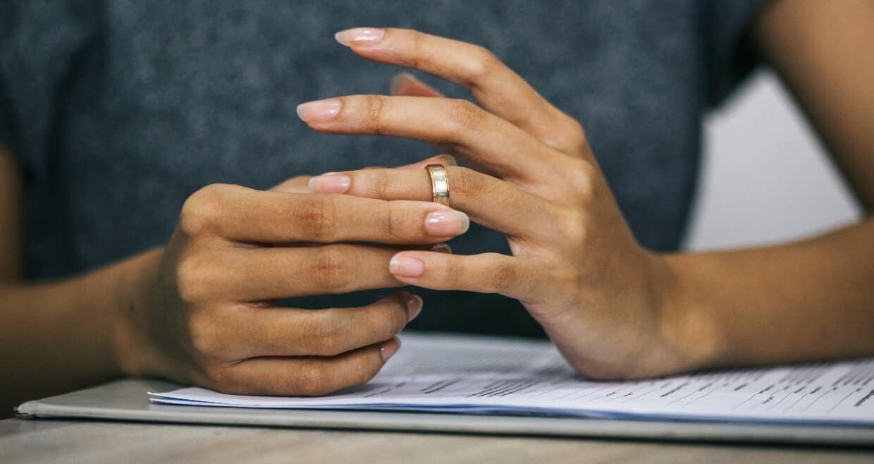 Woman taking off wedding ring