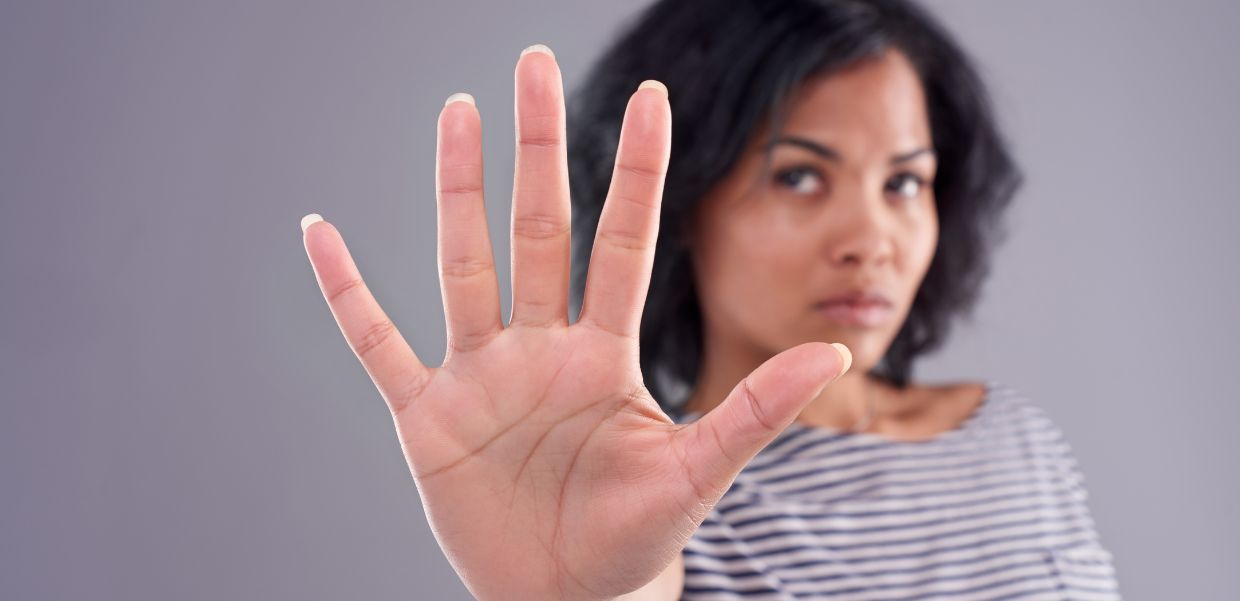 Woman with outstretched hand toward camera, gesturing