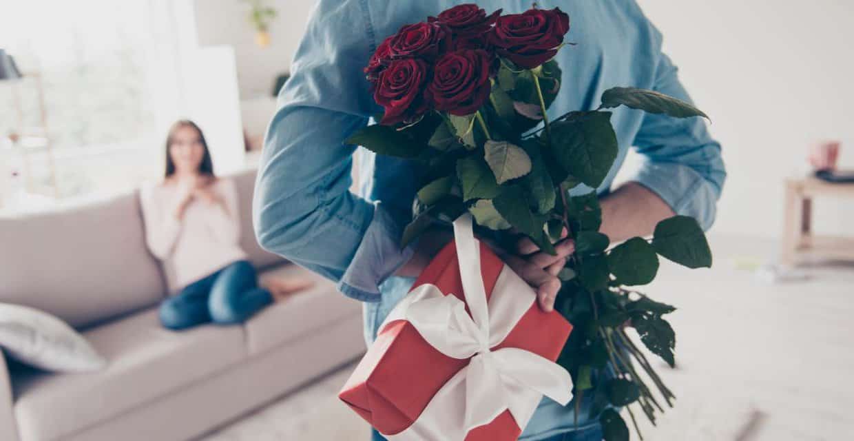 Photo of a man with a gift and flowers
