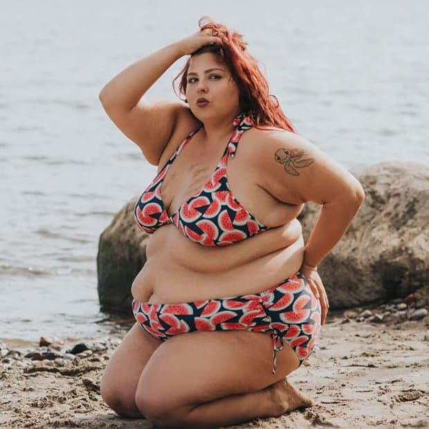 Curvy woman posing on beach with watermelon swimsuit
